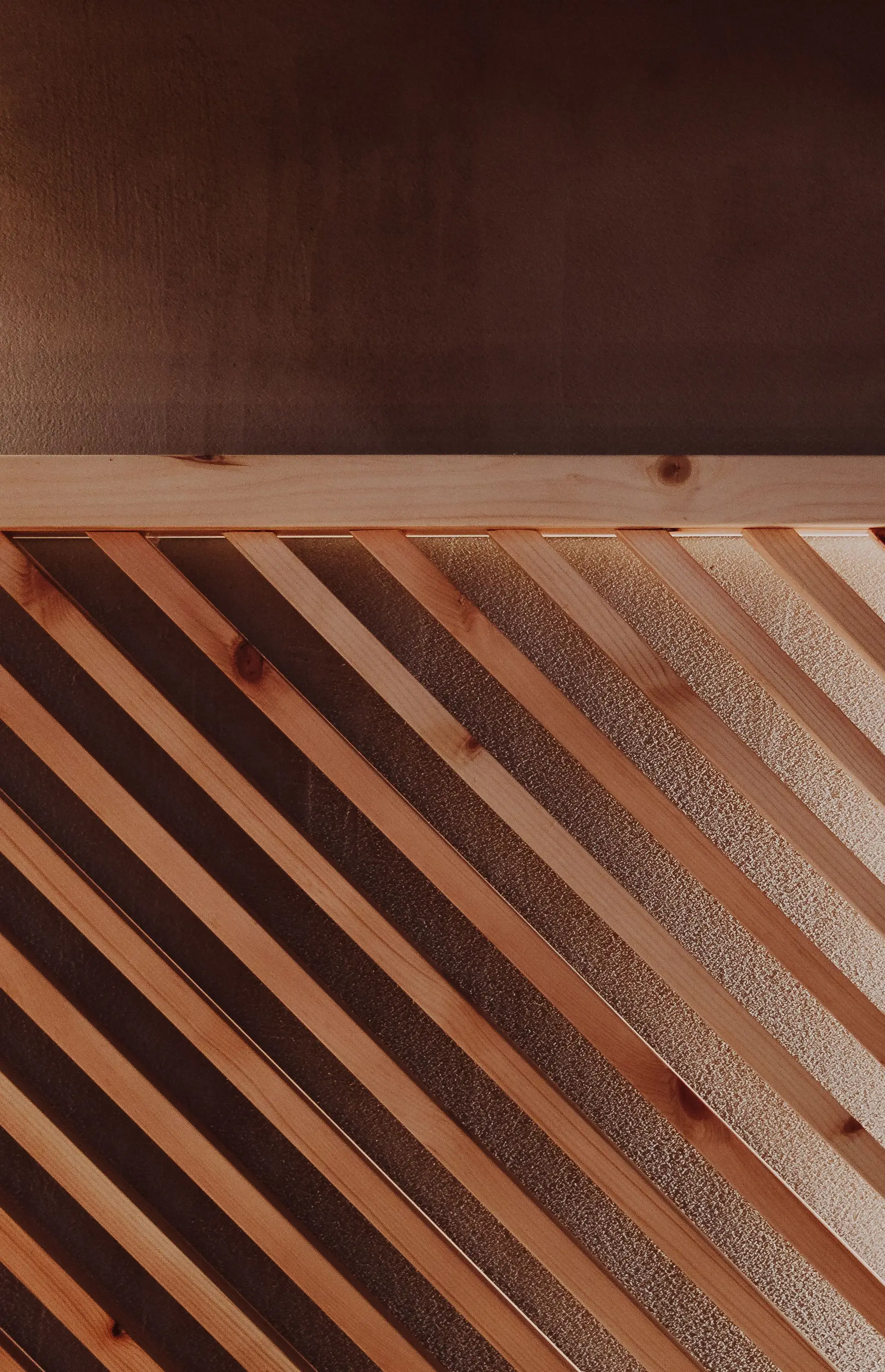 Warm architectural slatted timber wall showing lighting texture interaction
