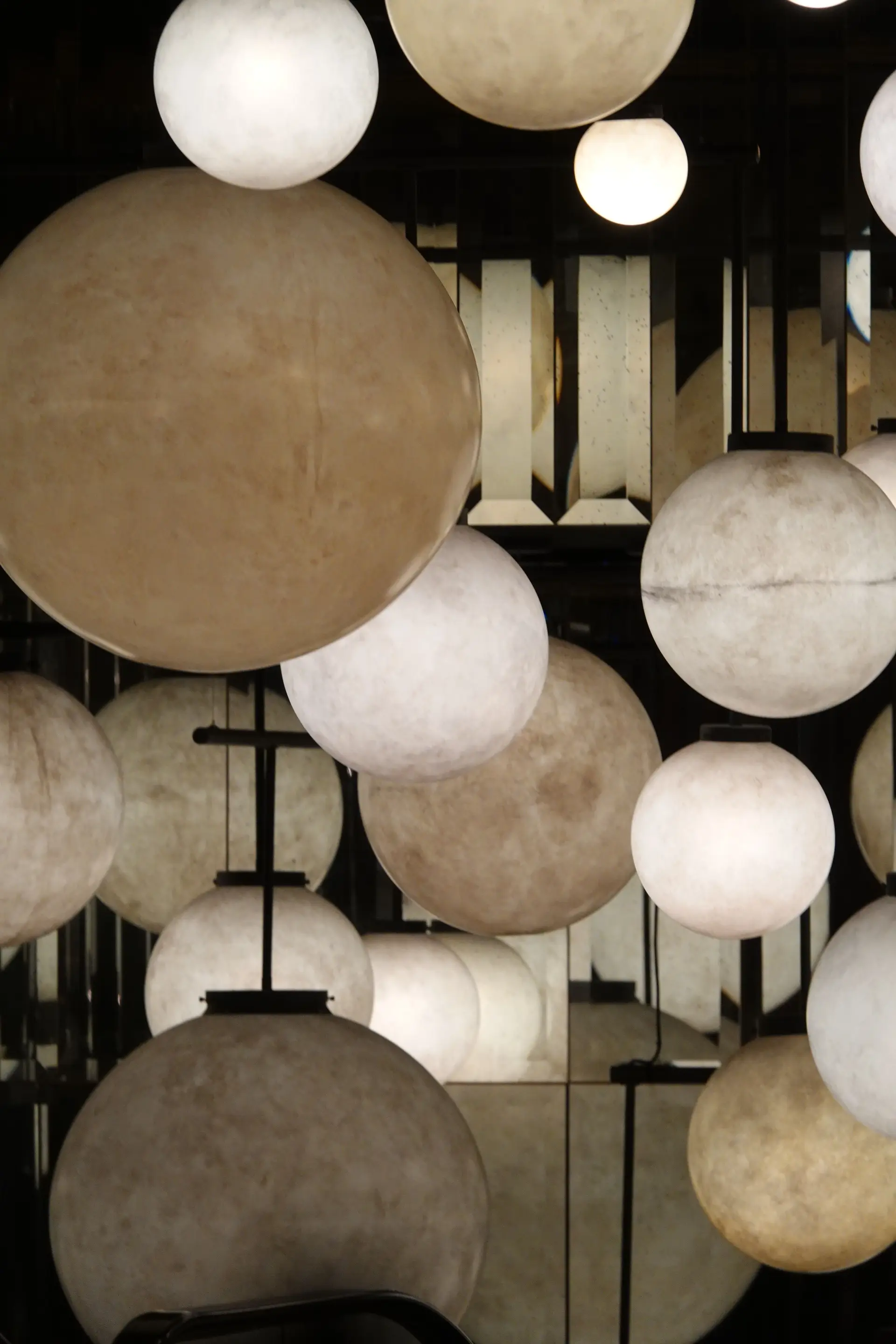 Ambient spherical chandeliers delivering balanced atmospheric glow