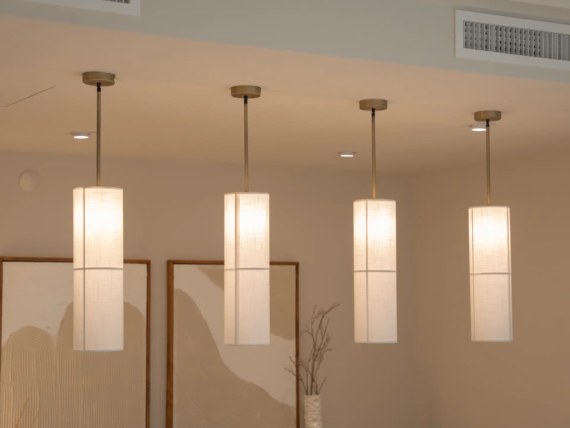 Atmospheric architectural living space with sculptural pendant lighting