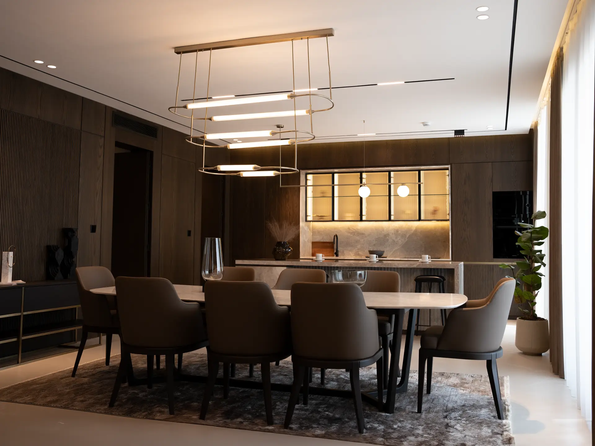 Sculptural pendant lighting fixture suspended in minimal dining interior