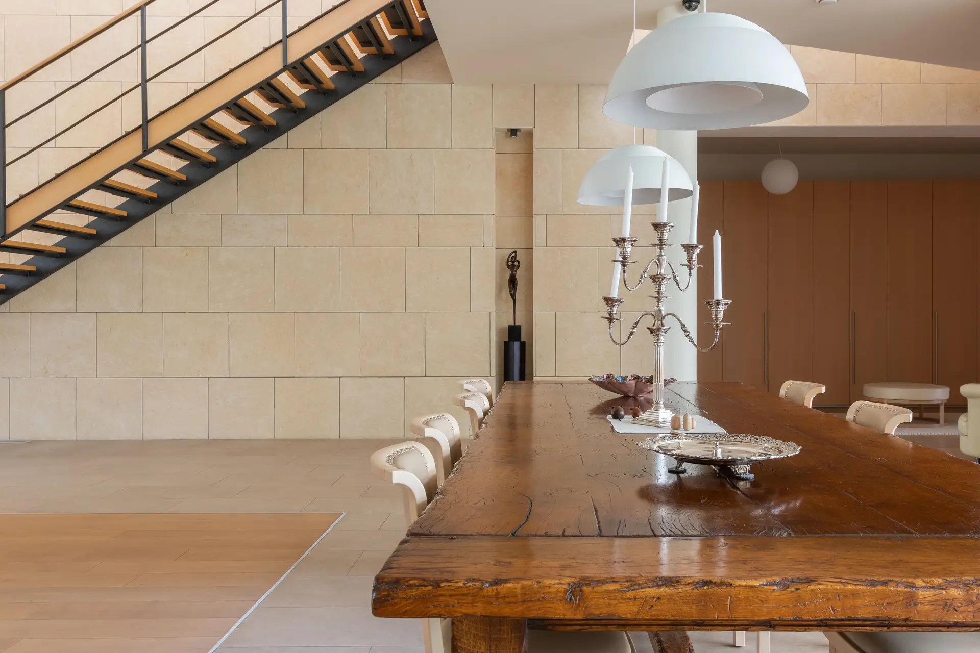 Refined contemporary dining space with pendant fixtures above wood table