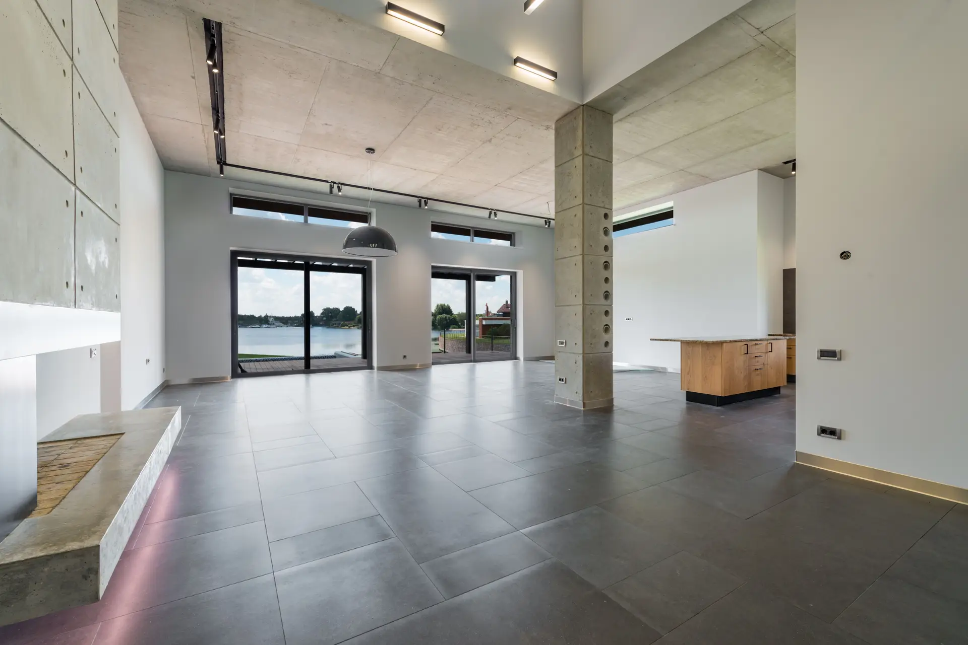 Panoramic architectural residence overlooking natural landscape with layered lighting